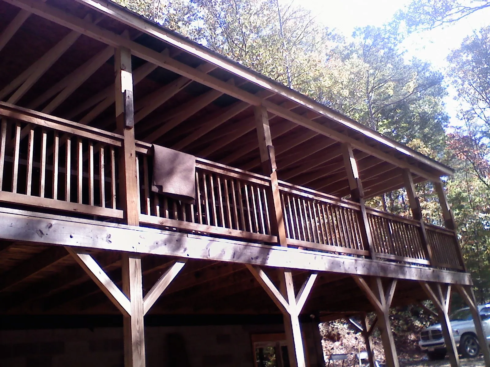 Timber framing under a new elevated porch and deck in New Hartford